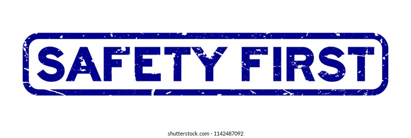 Grunge blue safety first square rubber seal stamp on white background