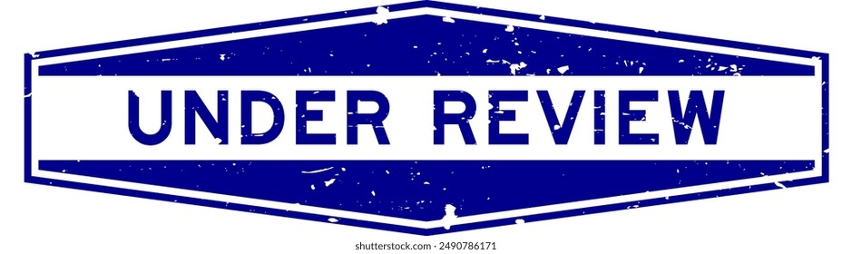 Grunge blue under review word hexagon rubber seal stamp on white background