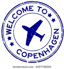 Grunge blue welcome to copenhagen word with plane icon round rubber seal stamp on white background