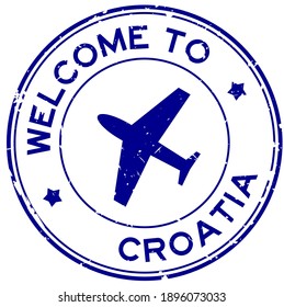 Grunge blue welcome to Croatia word with airplane icon round rubber seal stamp on white background