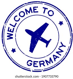 Grunge blue welcome to Germany word with airplane icon round rubber seal stamp on white background