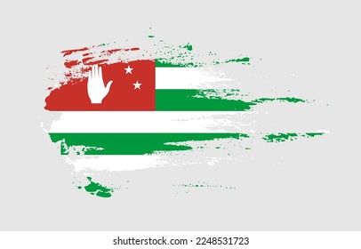 Grunge brush stroke flag of Abkhazia with painted brush splatter effect on solid background