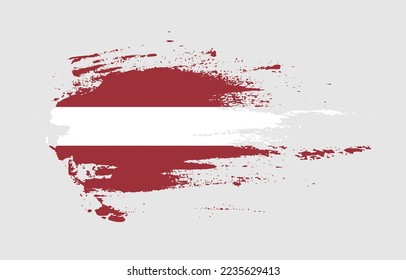 Grunge brush stroke flag of Latvia with painted brush splatter effect on solid background
