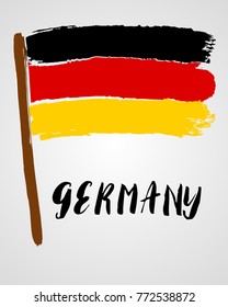 Grunge brush stroke with Germany national flag isolated on light grey background