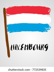 Grunge brush stroke with Luxembourg national flag isolated on light grey background
