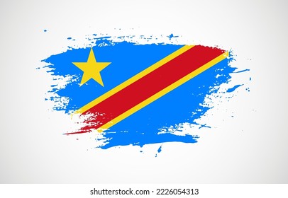 Grunge brush stroke with the national flag of Democratic Republic of the Congo on a white isolated background