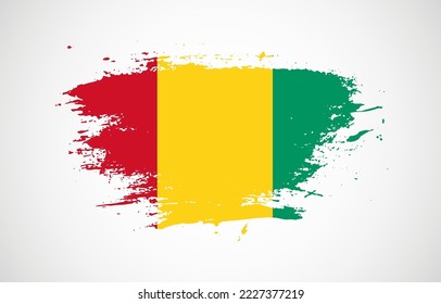 Grunge brush stroke with the national flag of Guinea on a white isolated background