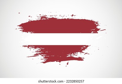 Grunge brush stroke with the national flag of Latvia on a white isolated background