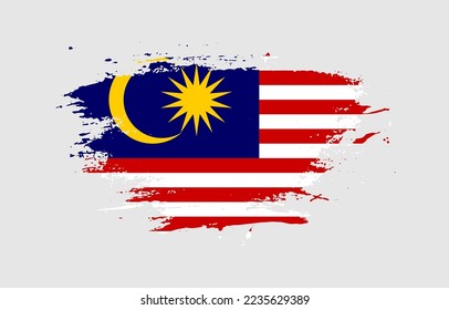 Grunge brush stroke with the national flag of Malaysia on a white isolated background