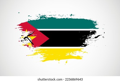 Grunge brush stroke with the national flag of Mozambique on a white isolated background