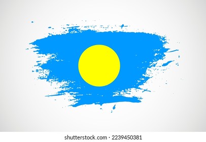 Grunge brush stroke with the national flag of Palau on a white isolated background