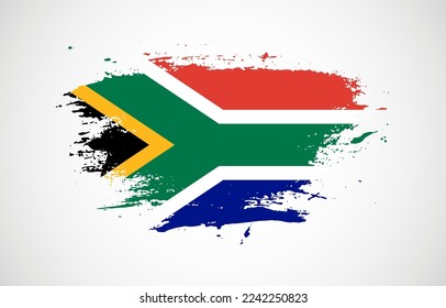 Grunge brush stroke with the national flag of South Africa on a white isolated background