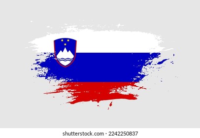 Grunge brush stroke with the national flag of Slovenia on a white isolated background
