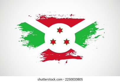 Grunge brush stroke with the national flag of Burundi on a white isolated background