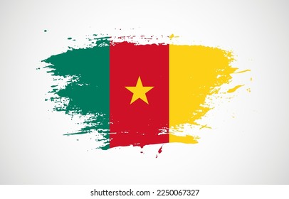 Grunge brush stroke with the national flag of Cameroon on a white isolated background