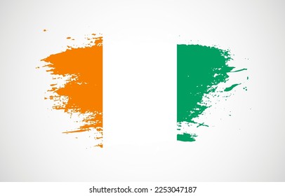 Grunge brush stroke with the national flag of Cote dIvoire on a white isolated background