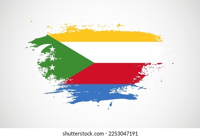 Grunge brush stroke with the national flag of Comoros on a white isolated background