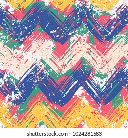 Grunge chevron vector pattern on splashed and splattered watercolor paint . Bold zigzag print with ethnic, tribal and retro motif in vintage boho chic style. Modern hand drawn texture in bright colors