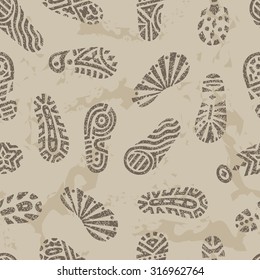 Grunge footprints Seamless pattern. Hand drawn doodles shoe tracks - Vector illustration. Gray background.
