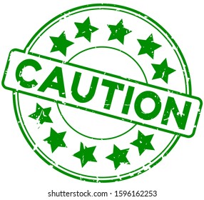 Grunge green caution word round with star icon rubber seal stamp on white background