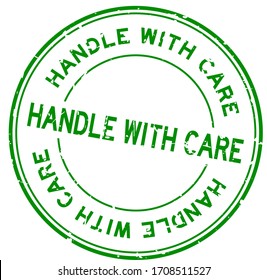 Grunge green handle with care word round rubber seal stamp on white background
