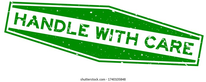 Grunge green handle with care word hexagon rubber seal stamp on white background