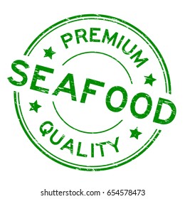 Grunge green premium quality seafood round rubber seal stamp on white background