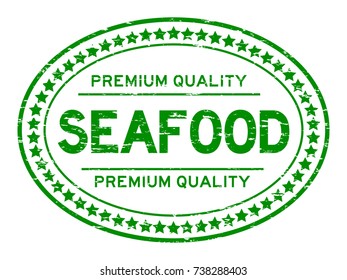 Grunge green premium quality seafood oval rubber seal stamp on white background