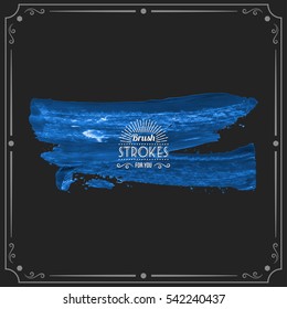 Grunge hand - painted brush stroke on a dark background. Expressive vector element for design.