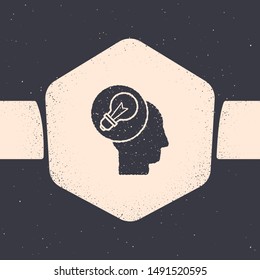 Grunge Human head with lamp bulb icon isolated on grey background. Monochrome vintage drawing. Vector Illustration