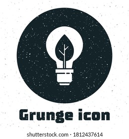 Grunge Light bulb with leaf icon isolated on white background. Eco energy concept. Alternative energy concept. Monochrome vintage drawing. Vector.