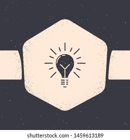Grunge Light bulb with rays shine and concept of idea icon isolated on grey background. Energy and idea symbol. Inspiration concept. Monochrome vintage drawing. Vector Illustration