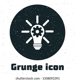 Grunge Light bulb with rays shine and gear inside icon isolated on white background. Innovation concept.  Vector Illustration