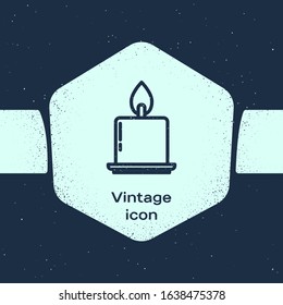 Grunge line Burning candle in candlestick icon isolated on blue background. Cylindrical candle stick with burning flame. Monochrome vintage drawing. Vector Illustration