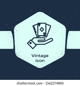 Grunge line Hand holding deck of playing cards icon isolated on blue background. Casino gambling. Monochrome vintage drawing. Vector Illustration