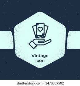 Grunge line Hand holding playing cards icon isolated on blue background. Casino game design. Monochrome vintage drawing. Vector Illustration