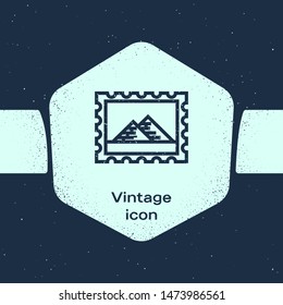 Grunge line Postal stamp and Egypt pyramids icon isolated on blue background. Monochrome vintage drawing. Vector Illustration