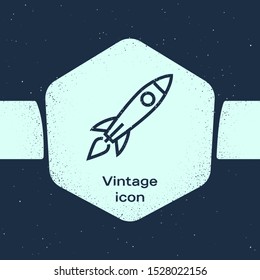 Grunge line Rocket ship with fire icon isolated on blue background. Space travel. Monochrome vintage drawing. Vector Illustration