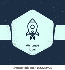 Grunge line Rocket ship with fire icon isolated on blue background. Space travel. Monochrome vintage drawing. Vector Illustration