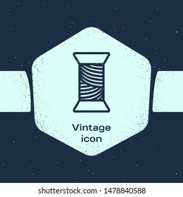Grunge line Sewing thread on spool icon isolated on blue background. Yarn spool. Thread bobbin. Monochrome vintage drawing. Vector Illustration
