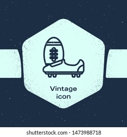 Grunge line Soccer or football shoes with spikes icon isolated on blue background. American football boot and ball. Monochrome vintage drawing. Vector Illustration
