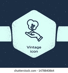 Grunge line Tree in hand of environmental protection icon isolated on blue background. Seed and seedling. Planting sapling. Ecology concept. Monochrome vintage drawing. Vector Illustration