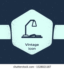 Grunge line Workplace with table lamp and open book icon isolated on blue background. Table office lamp. Monochrome vintage drawing. Vector Illustration