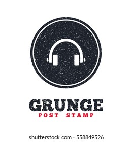 Grunge post stamp. Circle banner or label. Headphones sign icon. Earphones button. Dirty textured web button. Vector