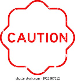 Grunge red caution word rubber seal stamp on white background