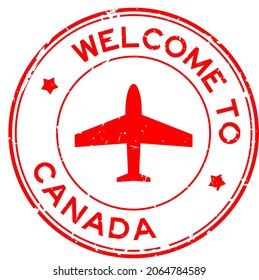 Grunge red welcome to Canada word with airplane icon round rubber seal stamp on white background