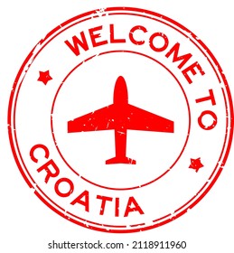 Grunge red welcome to Croatia word with airplane icon round rubber seal stamp on white background