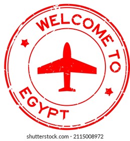 Grunge red welcome to Egypt word with airplane icon round rubber seal stamp on white background