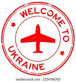 Grunge red welcome to Ukraine word with airplane icon round rubber seal stamp on white background