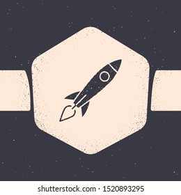 Grunge Rocket ship with fire icon isolated on grey background. Space travel. Monochrome vintage drawing. Vector Illustration